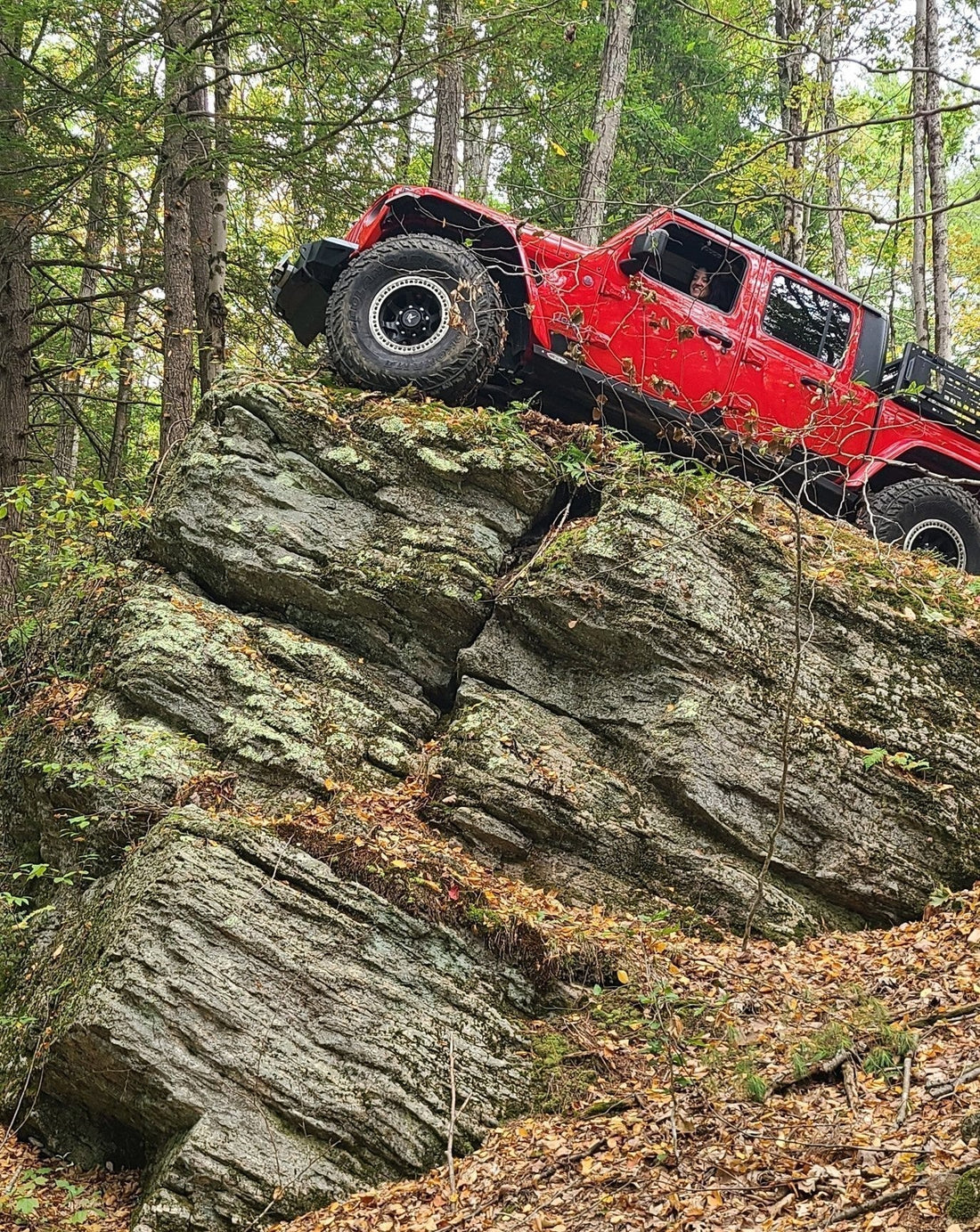 Red Jeep Gladiator perched on King's Rock at Three Ridges Events OffRoad Park in Hinsdale, NH